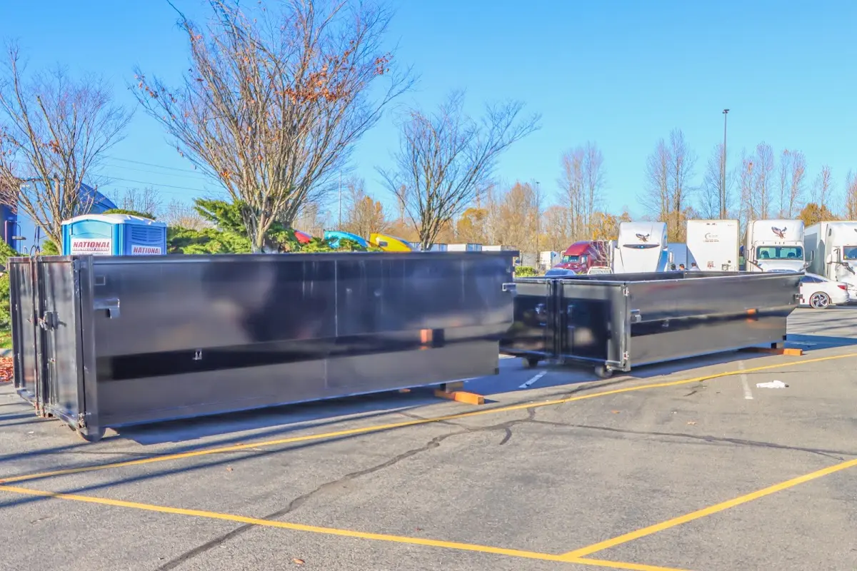 Professional dumpster rental service with roll-off container on residential driveway in Pleasant Grove